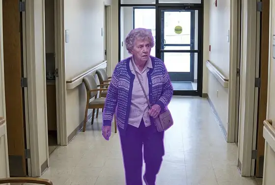 AI segmentation mask on a confused elderly patient walking towards an exit, wandering risk