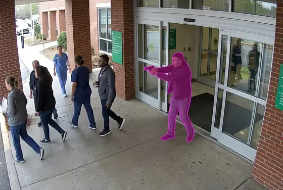 AI segmentation mask on a brandished weapon at a hospital entrance, weapon detection