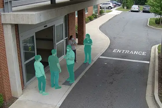 AI segmentation mask on people standing in a drive-through lane at a hospital entrance
