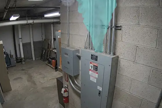 AI segmentation mask on early smoke at ceiling level near an electrical panel