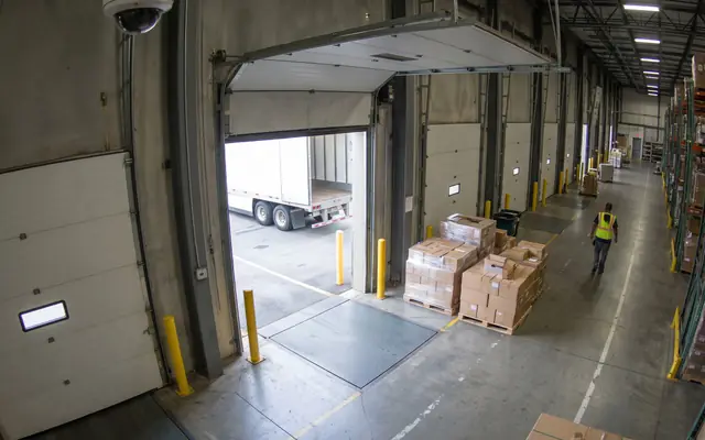 An emergency exit doorway blocked by stacked boxes and debris