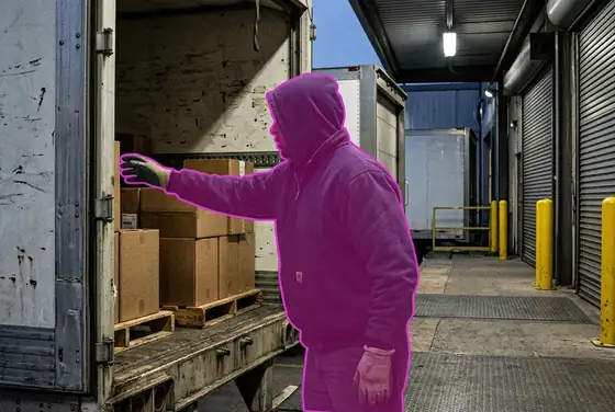 AI segmentation mask on a hand reaching into an open trailer at a loading dock