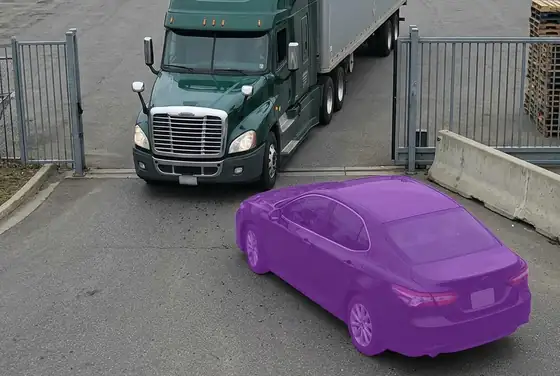 AI segmentation mask on a second vehicle tailgating a truck through a yard gate