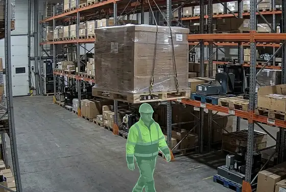 AI segmentation mask on a worker walking beneath a suspended load on a high rack