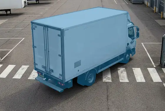 AI segmentation mask on a truck reversing into a pedestrian crossing inside the yard