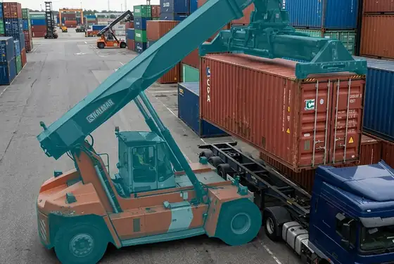 AI segmentation flagging a reach stacker lifting a container over a parked truck cab