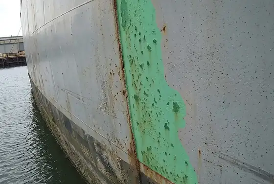 AI segmentation flagging pitting corrosion along a hull plate above the boot top