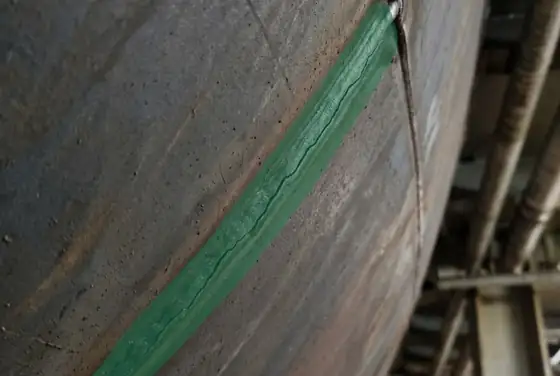 AI segmentation highlighting a hairline crack along a weld seam on a hull plate