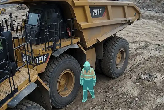 AI segmentation flagging a worker inside a haul-truck blind spot