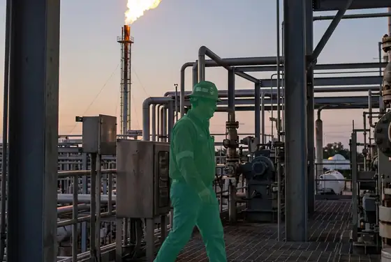 AI segmentation mask flagging a worker without a flame-resistant coverall near a flare