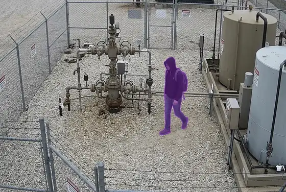AI segmentation mask highlighting an unauthorized person inside a restricted well pad