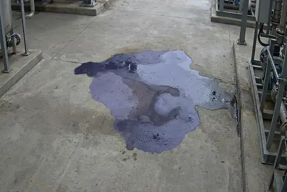 AI segmentation mask highlighting a hydrocarbon spill on process-area concrete