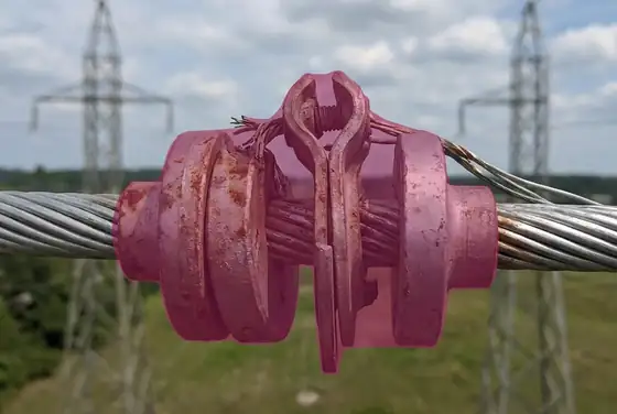 AI segmentation mask on a damaged Stockbridge vibration damper