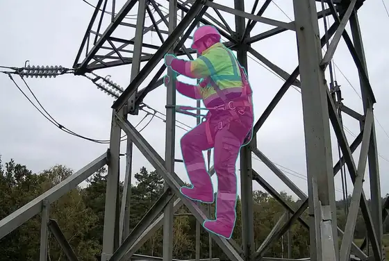 AI segmentation mask on a worker climbing a restricted transmission tower