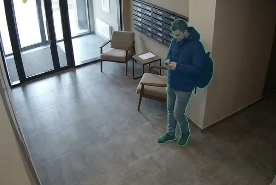 AI segmentation mask on a person standing and loitering in a residential lobby