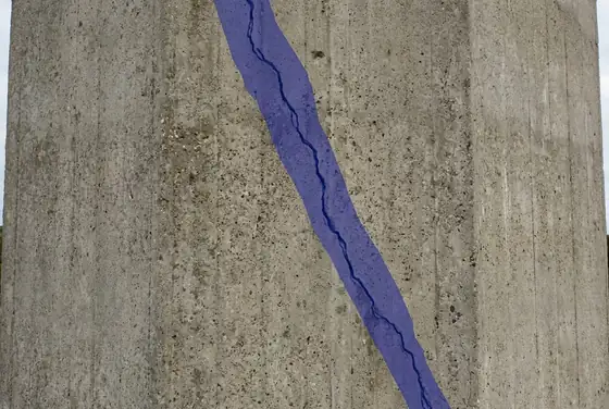 AI segmentation mask on a hairline crack running across a tower facade