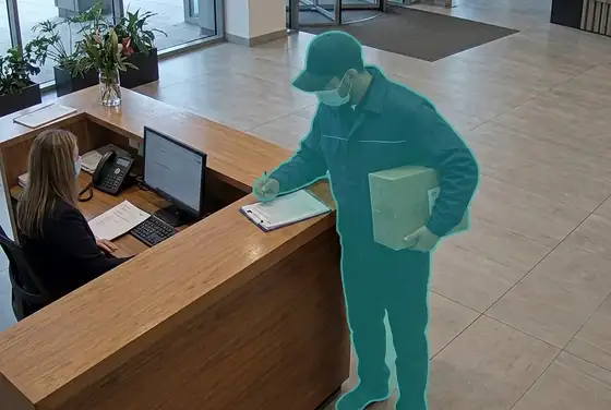 AI segmentation mask on a delivery driver checking in at a tower reception desk