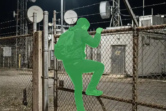 AI segmentation mask flagging a person breaching a telecom compound perimeter fence