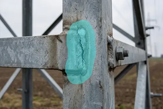 AI segmentation mask flagging a cracked welded joint on a tower leg