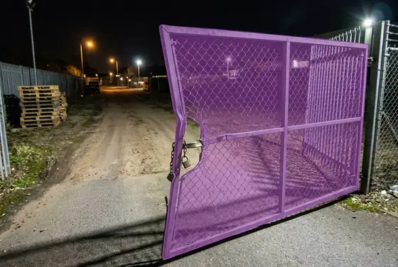 AI segmentation mask on a forced-open site gate at night