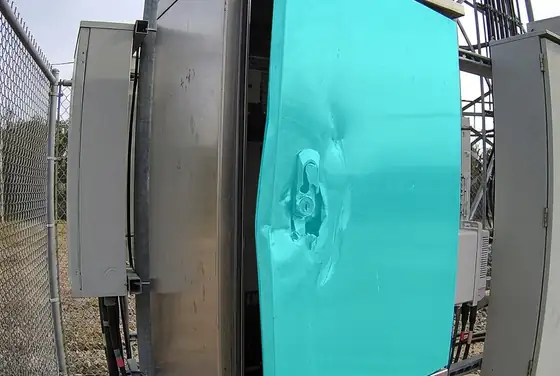 AI segmentation mask on a tampered equipment cabinet door at a cell site