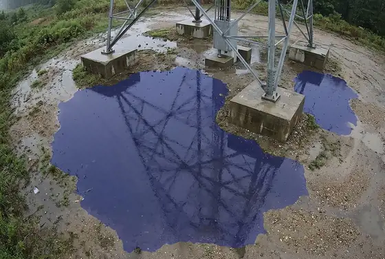 AI segmentation mask on standing water pooling at a tower foundation after rain