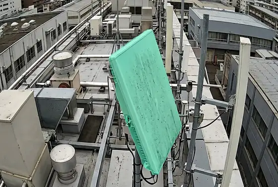 AI segmentation mask flagging a tilted panel antenna on a rooftop