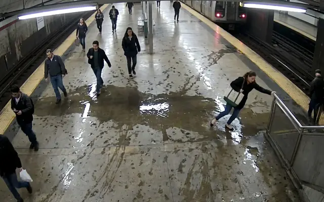 An oil and water spill spreading across a concrete factory floor