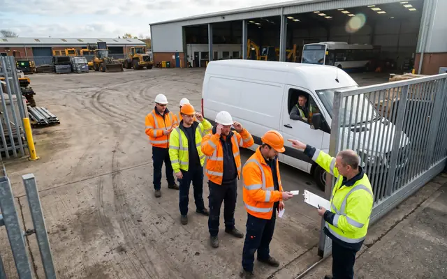 A crowded site entrance at shift start with many workers entering at once