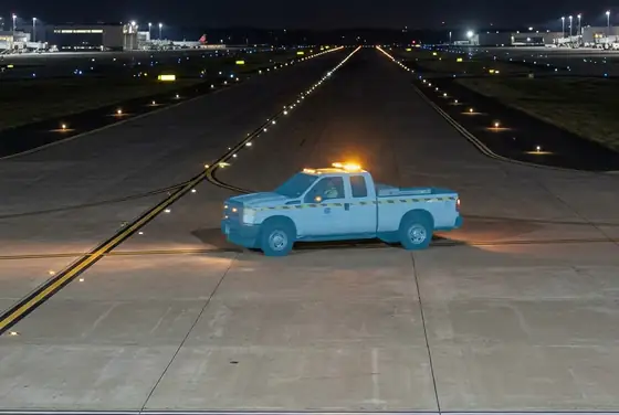 AI segmentation mask flagging a service vehicle crossing an active runway at night