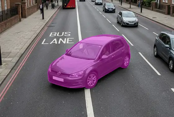 AI segmentation mask flagging a car in a dedicated bus lane on a city road