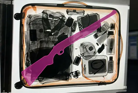 AI segmentation mask flagging a long firearm outline in a security X-ray image