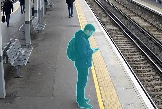 AI segmentation mask flagging a person loitering near a platform edge