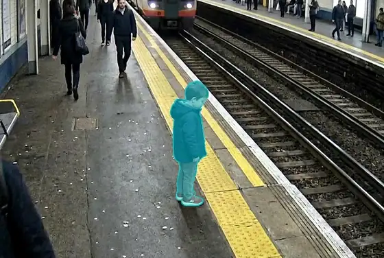AI segmentation mask flagging an unaccompanied child near a station platform