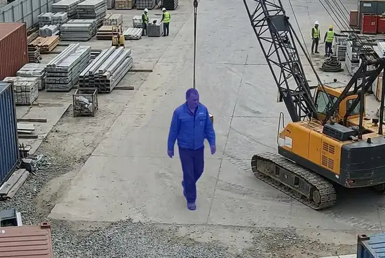 AI segmentation mask flagging a depot worker without a hard hat near a moving crane
