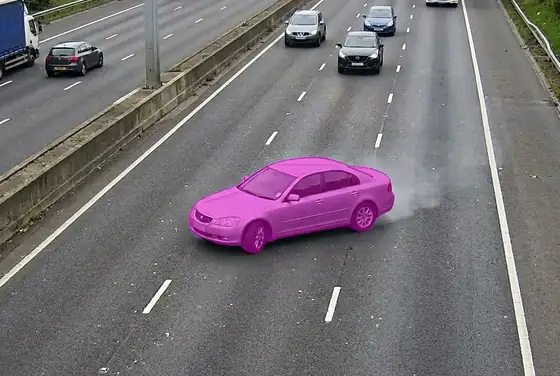 AI segmentation mask highlighting a vehicle drifting between lanes on a motorway