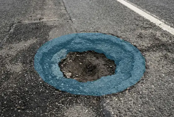 AI segmentation mask on a pothole