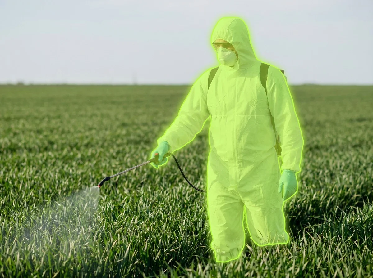 AI segmentation flagging protective coveralls while spraying crops